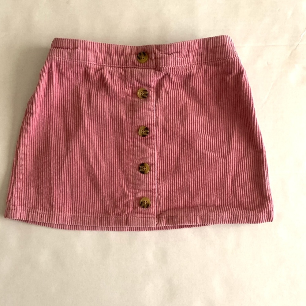 A cute pink skirt with unique buttons!